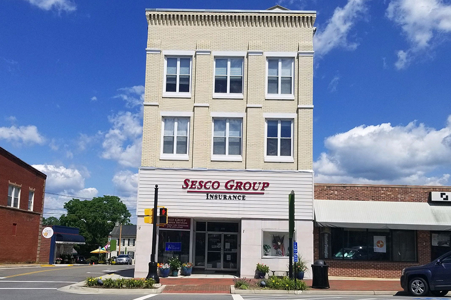 Wytheville, VA - Street View of Tall Sesco Group Insurance Office Building Located at a Corner Intersection in Wytheville, Virginia on a Sunny Day